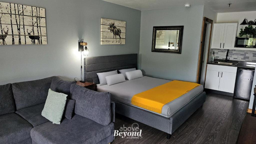 a small bedroom with a bed and a couch at Modern Moose Free Shuttle to SDC in Branson