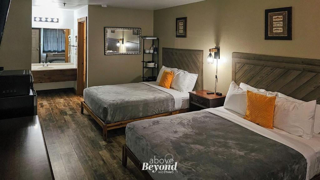 a hotel room with two beds and a bathroom at Modern in the Mountains Free Shuttle to SDC in Branson