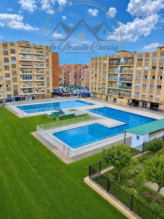 an overhead view of a large swimming pool in front of buildings at Cómodo apartamento a un paso del centro de Salamanca La Posada Charra 8 APART-37-278 in Salamanca