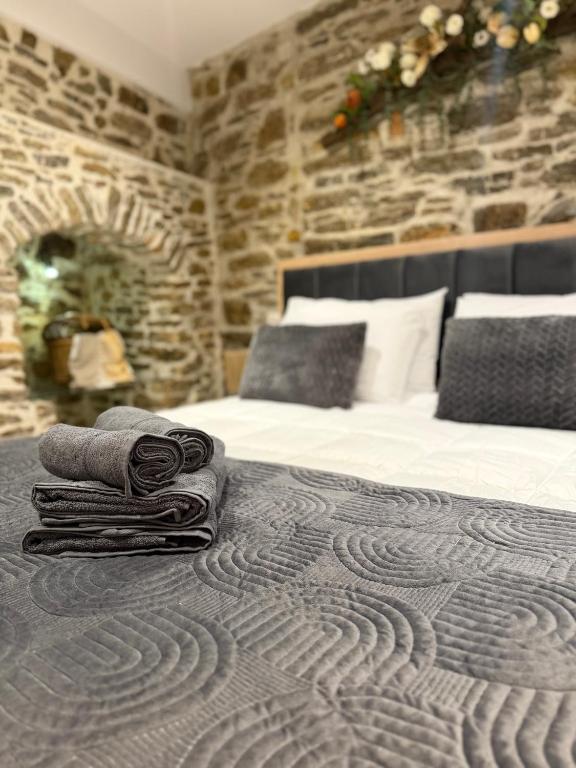 a bedroom with a bed with towels on it at La mina's house in Symi