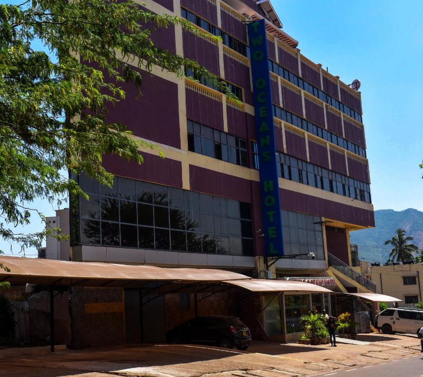 a building with a car parked in front of it at Two Oceans Hotel Voi in Voi