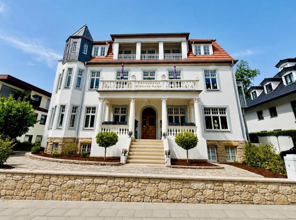a white house with a staircase in front of it at Parkresidenz Viktoria Luise in Bad Salzuflen