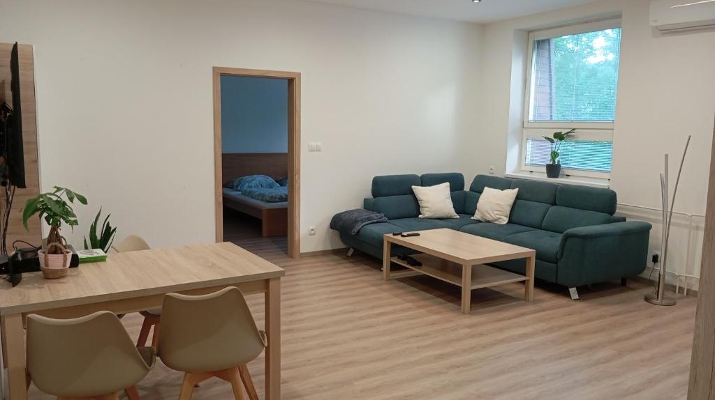 a living room with a couch and a table at Apartmán Istebné in Istebné