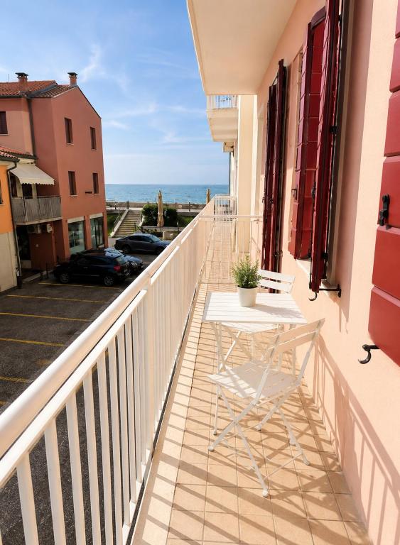 a balcony with a table and a view of the ocean at PETRONIA TRILO VISTA MARE - Agenzia Cocal in Caorle