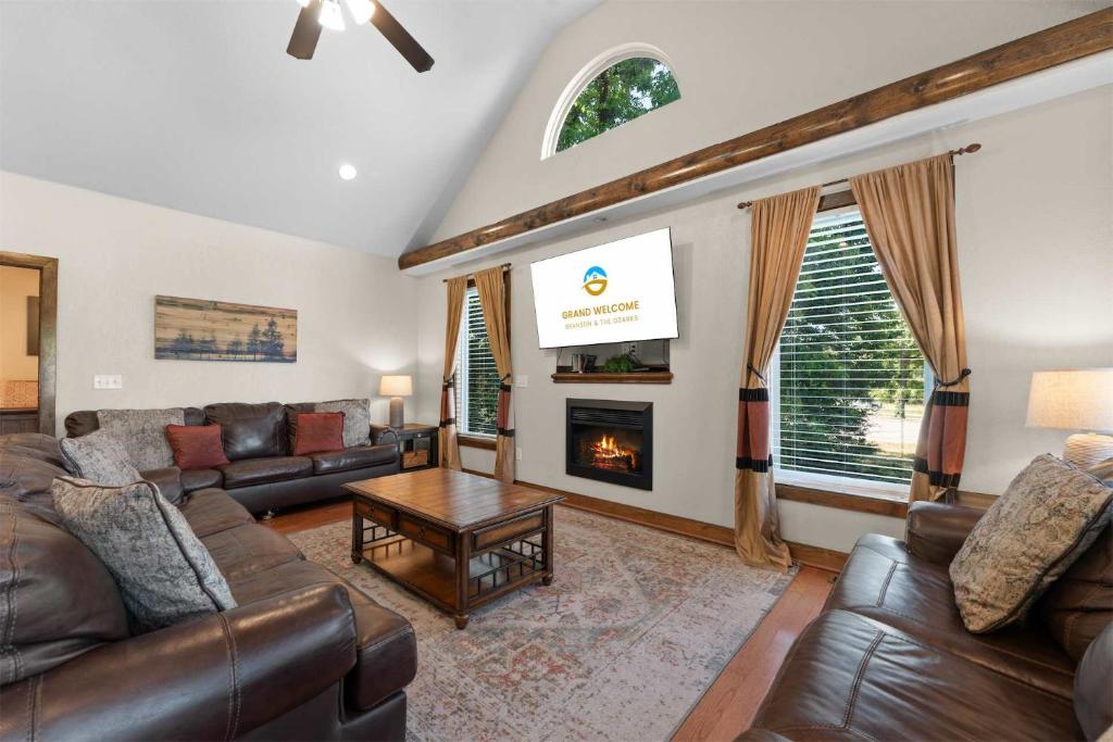 a living room with leather furniture and a fireplace at Hickory Hideaway with Communal Pool Access in Hollister