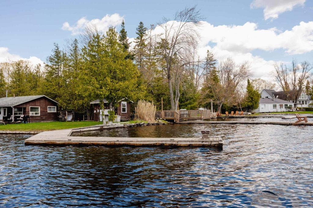 a dock in the middle of a body of water at Ambleside - 1-Bedroom Cottage #3 in Kawartha Lakes