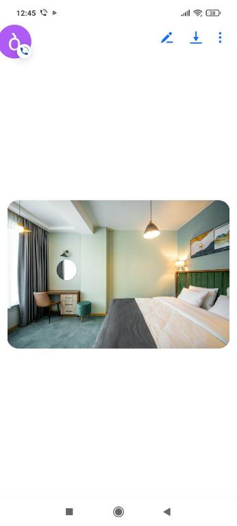 a hotel room with a bed and a desk at Gori Apartaments in Gori