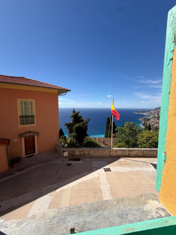 a view of the ocean from a house at La maison jaune in Roquebrune-Cap-Martin