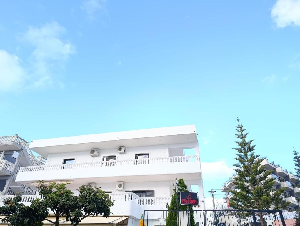 a white apartment building with a white balcony at Vila Erjoni in Ksamil