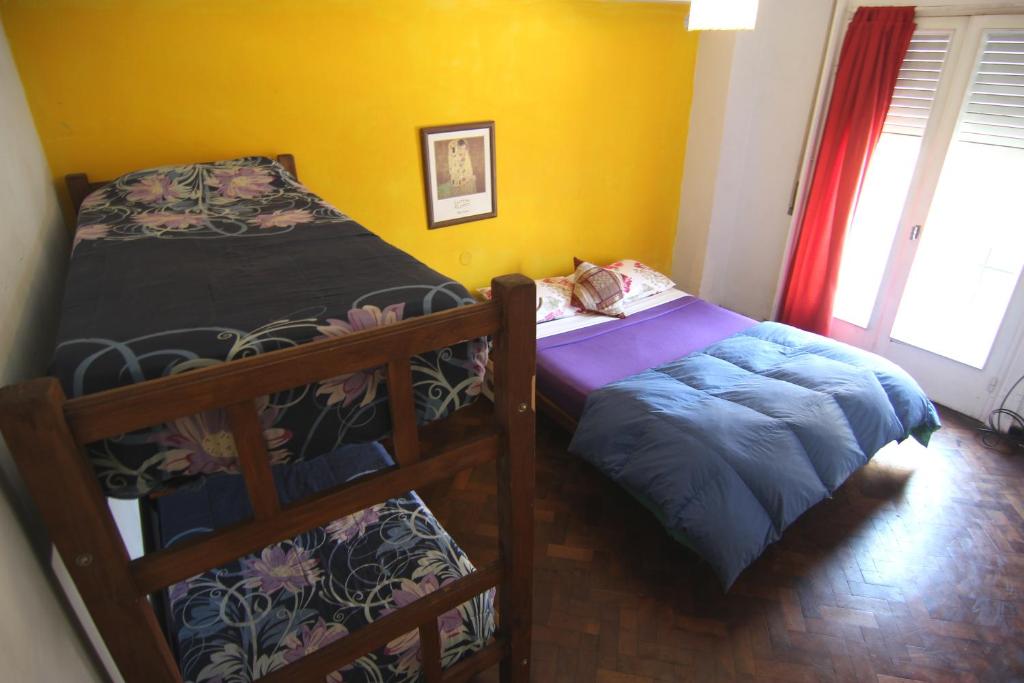 um quarto com 2 beliches e um gato deitado numa cama em mate! Hostel em Córdoba