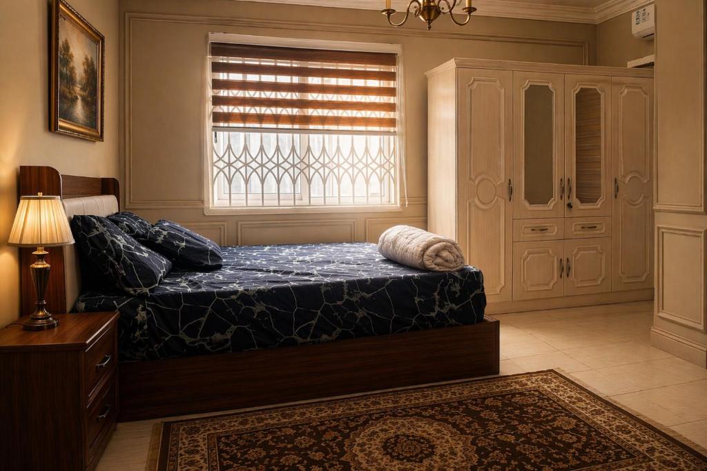 a bedroom with a bed and a window at CJ apartment kasoa in Kasoa