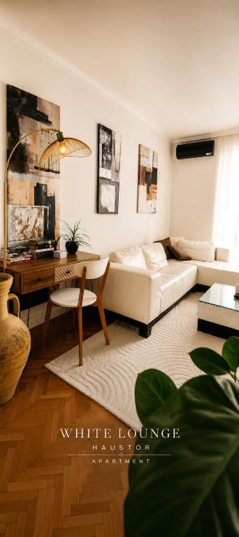 a living room with a white couch and a table at White Lounge Haustor in Podgorica