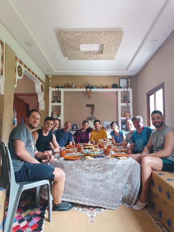 a group of people sitting around a table at Toubkal Guesthouse in Imlil