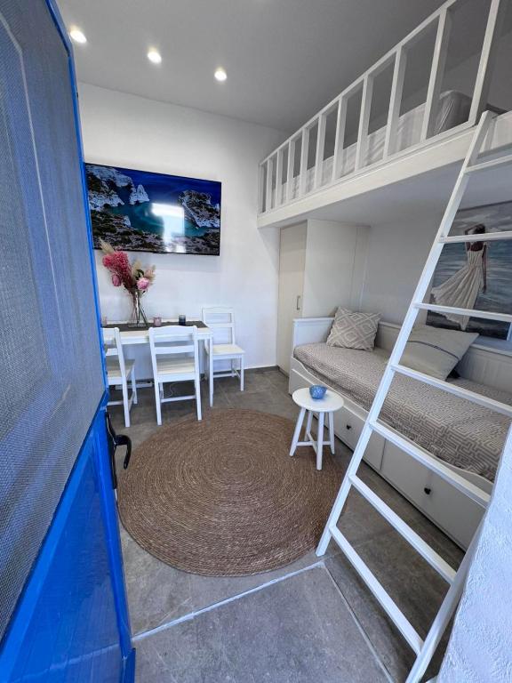a small room with a bunk bed and a table at Little Gem -A Cycladic Aura- Serifos in Serifos Chora