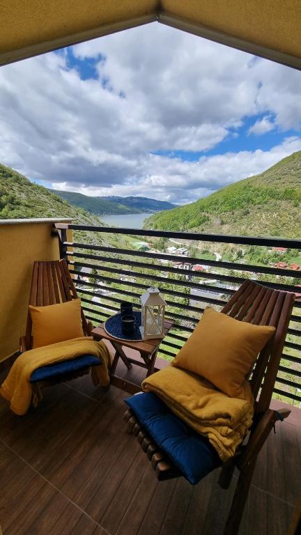 a balcony with two chairs and a table with a view at Panorama Apartment in Mavrovo