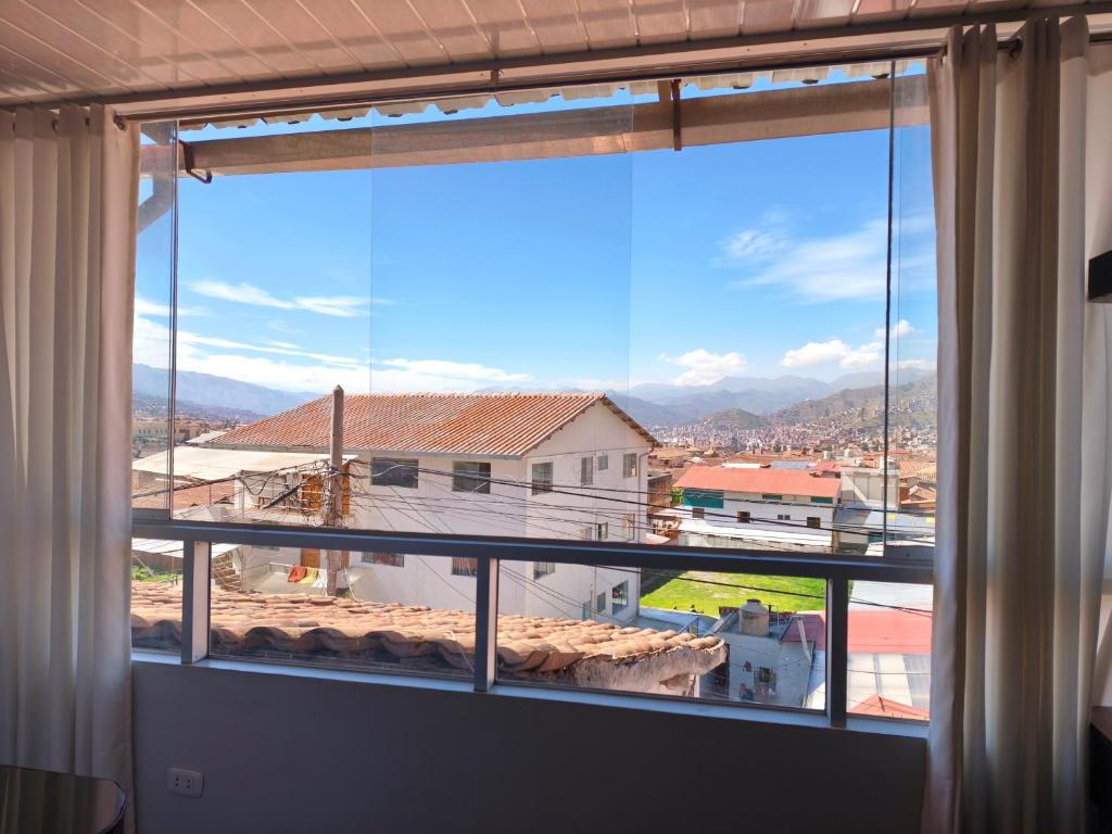 a window with a view of a mountain view at Cusco Center Apartment in Cusco