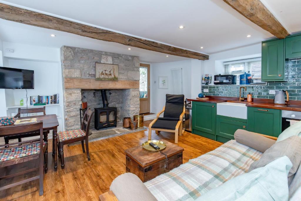 a living room with a couch and a fireplace at Cottage on Wells High Street in Wells