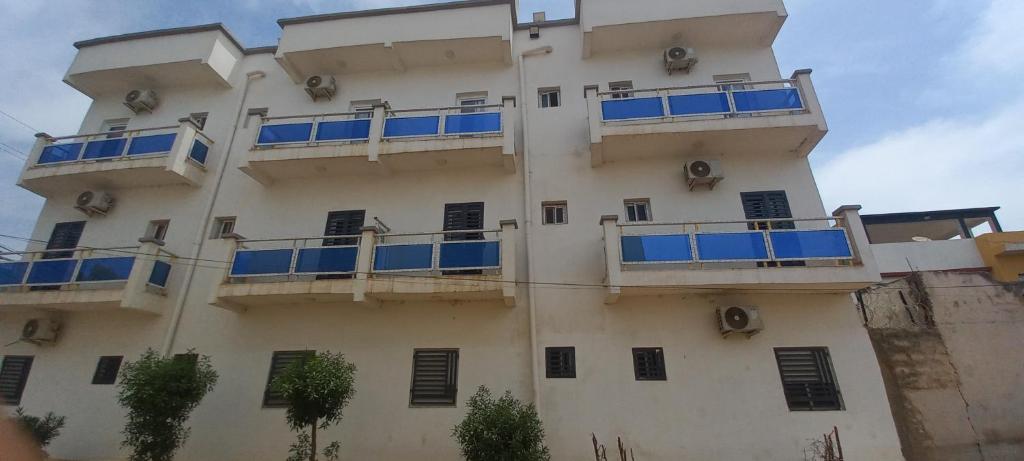 a building with blue balconies on the side of it at Résidence Diamant in Bamako