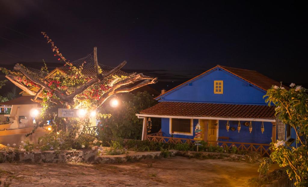 a blue house with a tree in front of it at night at Chalés de Triunfo in Triunfo