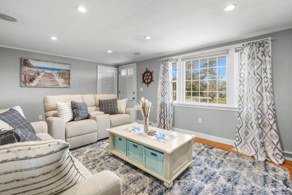 a living room with a couch and a table at Dog-Friendly Cape Cod Getaway with Fire Pit Yard in South Yarmouth