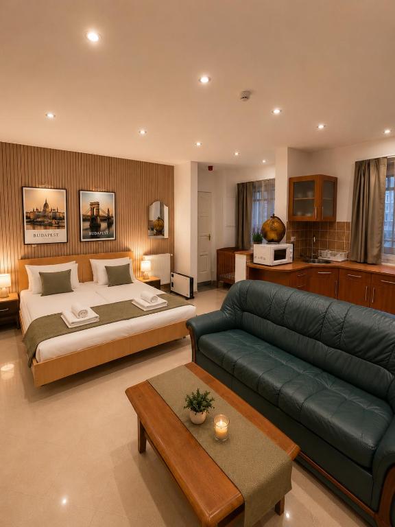 a large bedroom with a large bed and a couch at Esprit Residences Budapest in Budapest