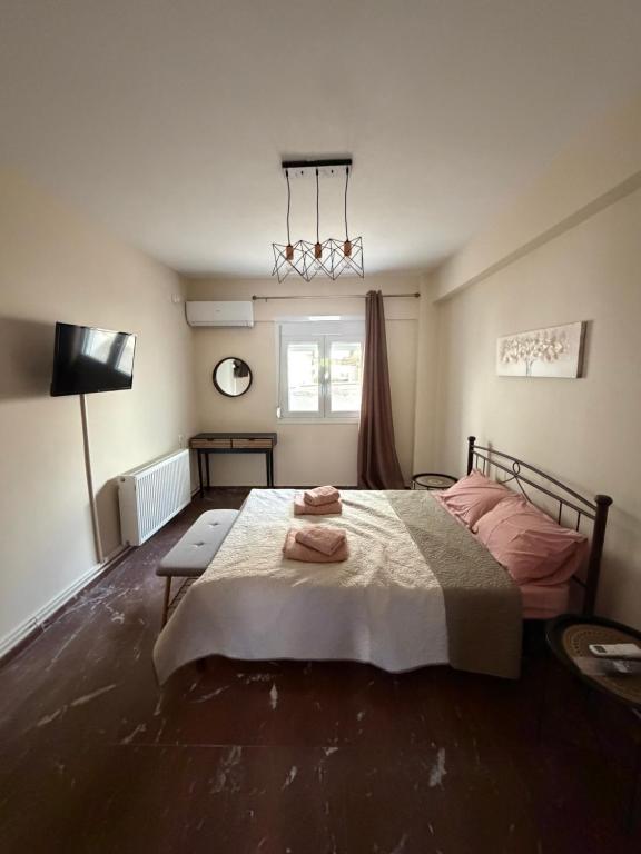 a bedroom with a bed with two towels on it at Derveni Nest Apartment in Rodhéa