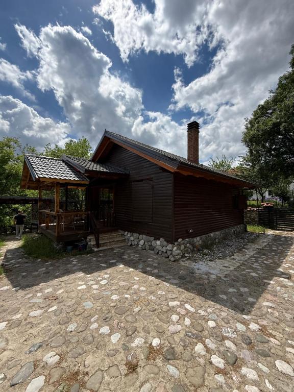 a small house with a pavilion in front of it at Vila Kadiu in Klos