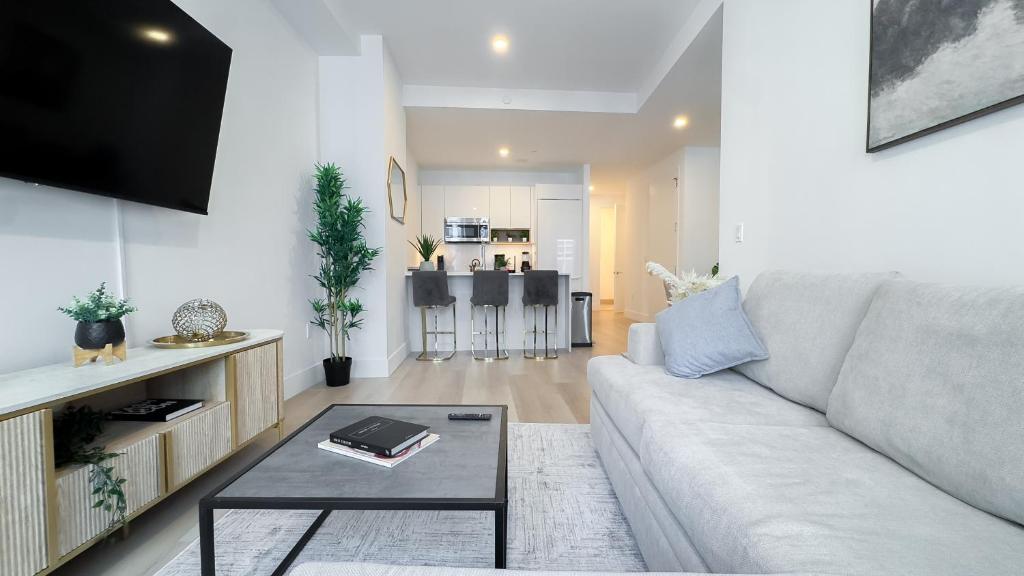 a living room with a couch and a table at Stylish 3BR Luxury Retreat in the Heart of FiDi in New York
