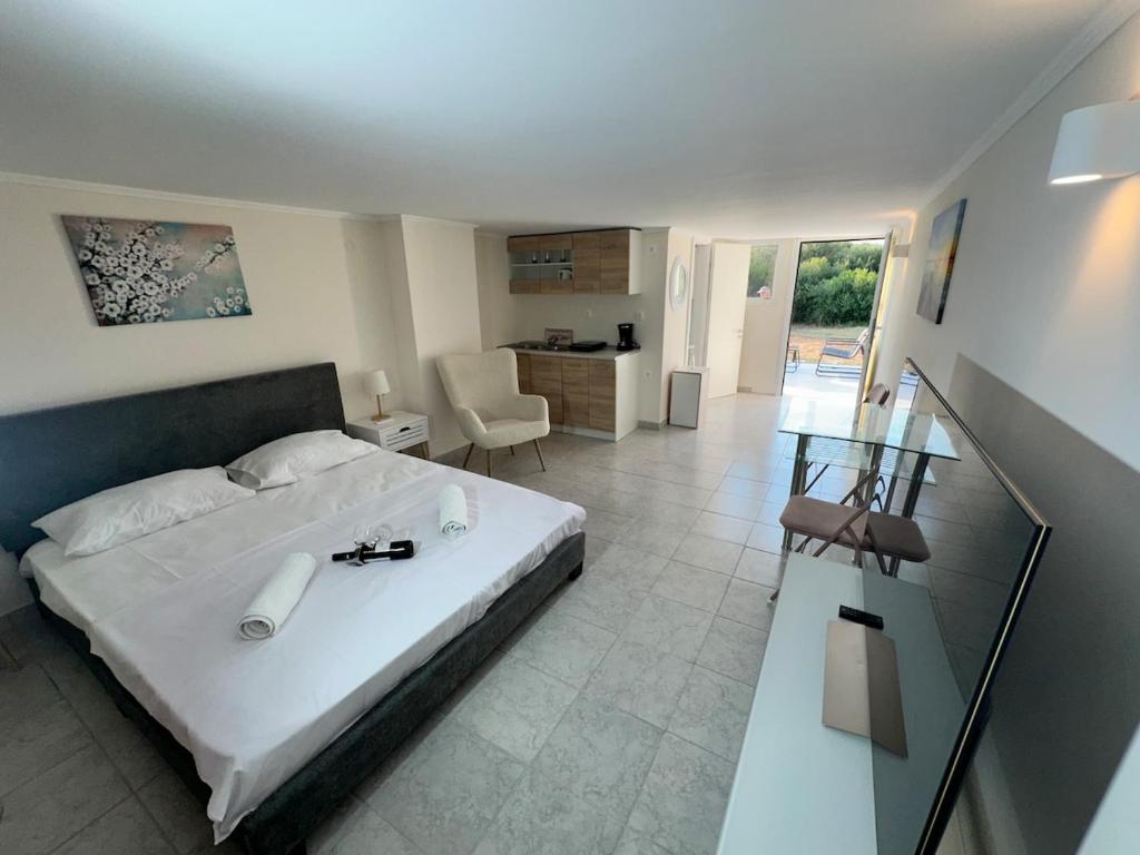 a bedroom with a bed and a living room at Alexandras Studio in Corfu
