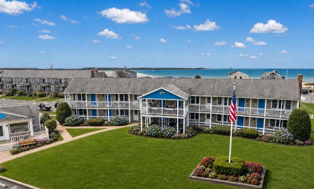 an exterior view of a large building with a flag at Colonial Acres Resort in Yarmouth