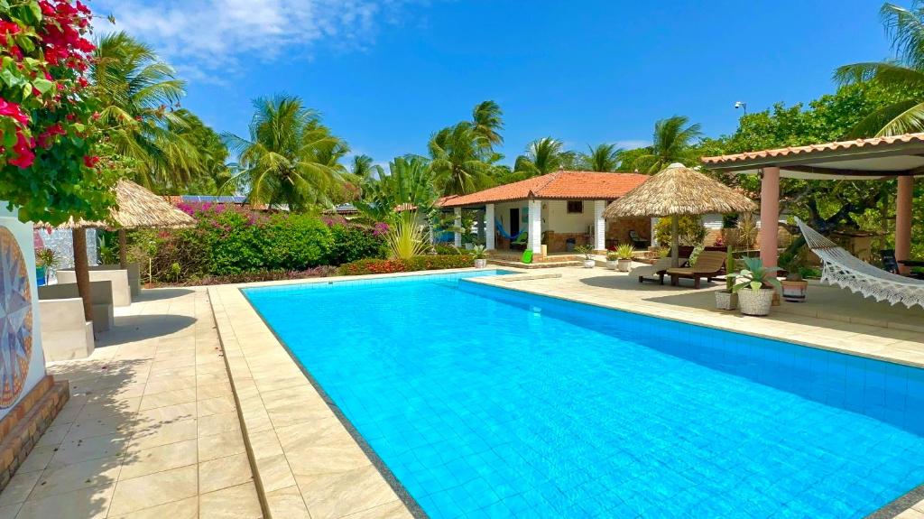 a swimming pool in front of a villa at Pousada em Paracuru Casa Eco Kite Surf & Relax in Paracuru