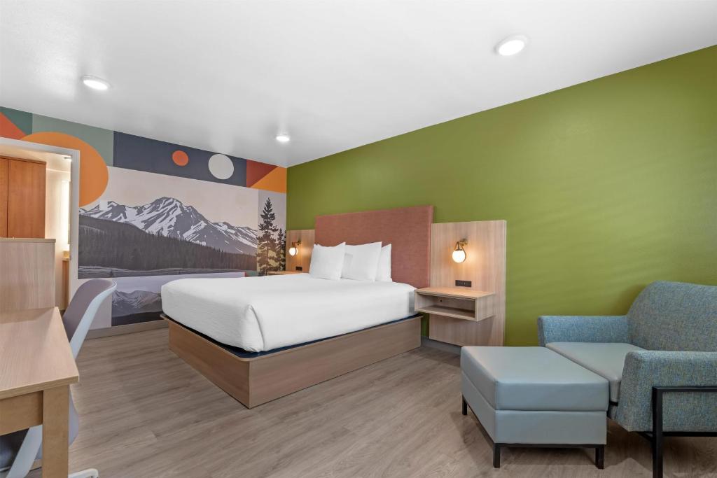 a hotel room with a bed and a chair at Best Western Plus Clocktower Inn in Billings