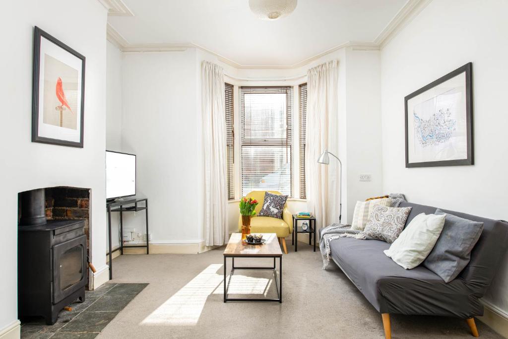 a living room with a couch and a fireplace at NEW Spacious and Bright House-Parking-By FabAccommodation in Bristol