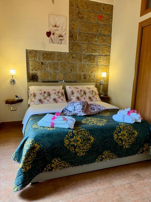 a bedroom with a bed with blankets and pillows at B&B Sunset Suite Belvedere in Sant'Agata de' Goti