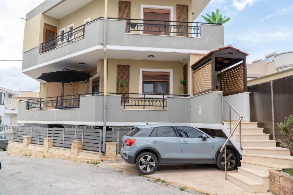 a car parked in front of a house at Miranda's Apartments in Koskinou
