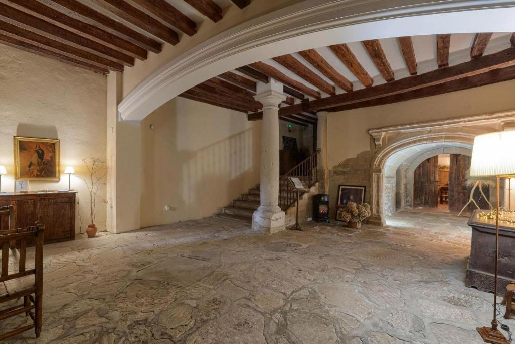 a large room with a staircase in a house at Casa Rural Palacio Armiñón in Armiñón