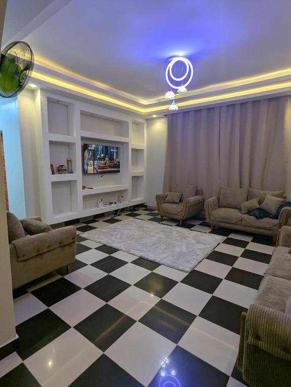 a living room with a checkered floor at Eden Vista Stays in Dar es Salaam