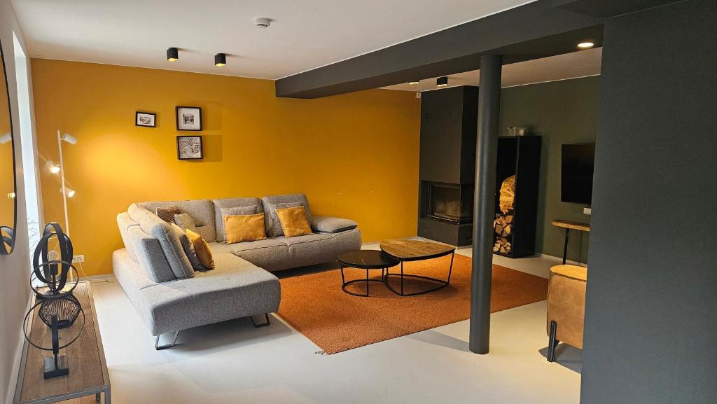 a living room with a couch and a table at Le Reflet de l'Ourthe in Durbuy