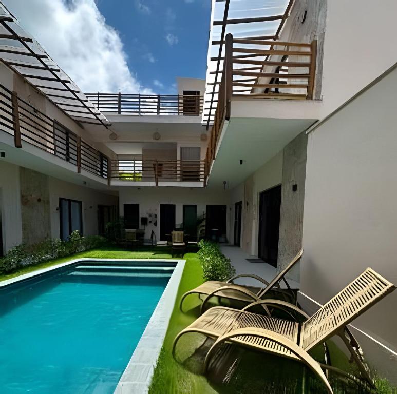 an image of a swimming pool in a house at Petit da Pipa Studios Privados in Pipa