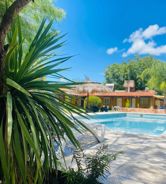 a resort with a swimming pool and a house at Posada La Ernestina Villa de las rosas in Villa Las Rosas