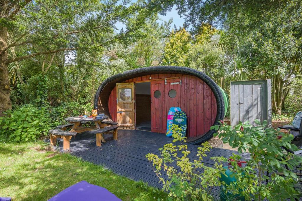 a circular shed with a picnic table in a yard at 1 Bed in Bude oc-s34849 in Bude