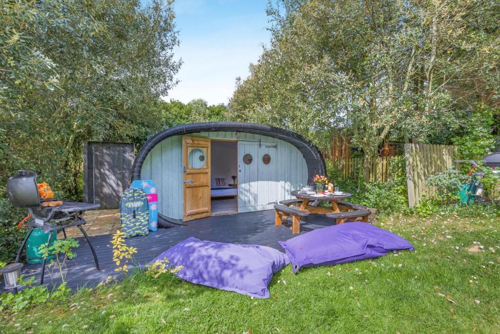 a backyard with a tent and a table in the grass at 1 Bed in Bude oc-s34847 in Bude