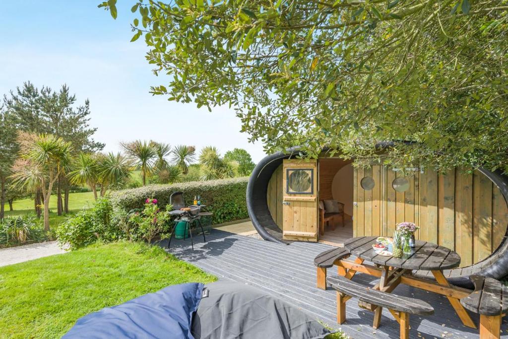 a pod house with a deck in a yard at 1 Bed in Bude oc-s34846 in Bude