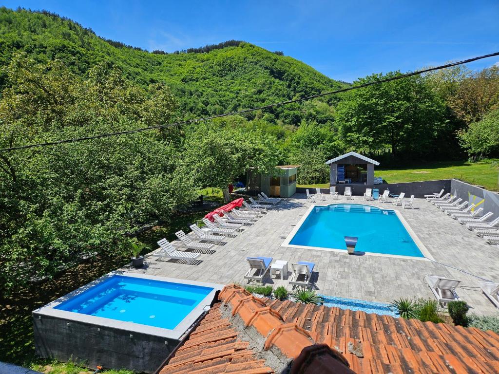 a swimming pool with lounge chairs and a swimming poolvisor at M&M Bazen resort Goražde in Goražde