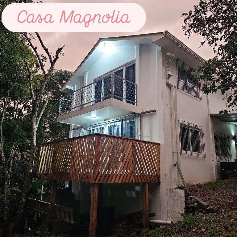 a casa magica house with a wooden balcony at Casa Magnolia in El Socorro