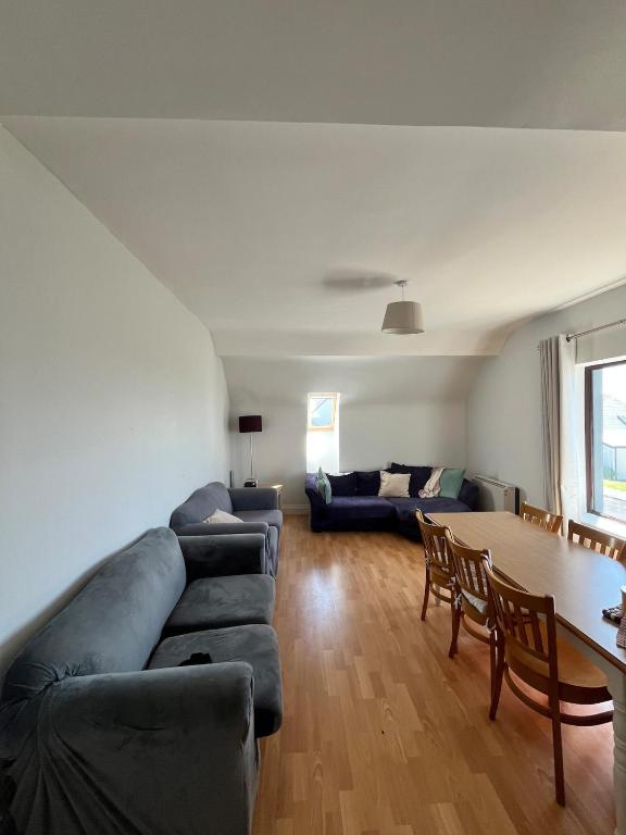 a living room with a couch and a table at Large Holiday Apartment Enniscrone in Enniscrone