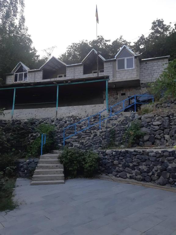 a house with stairs and a stone wall at Адами драхт in Garni