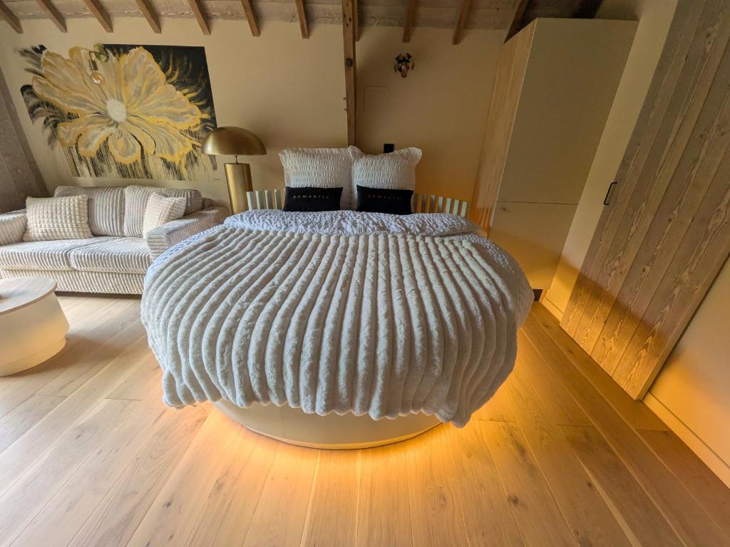 a bedroom with a large bed in a room at Domaine du Bois l'Abbé - Le Nid in Saint-Martin-Boulogne