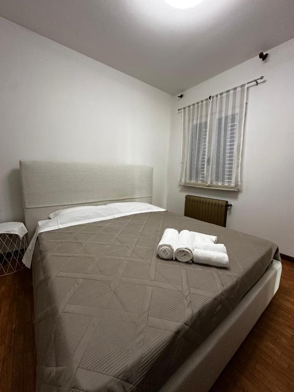 a bedroom with a large bed with two towels on it at La dolce casa in Verdellino
