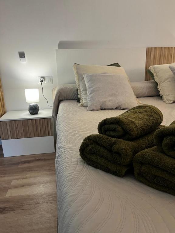 a bedroom with a bed with towels on it at Casa Portalet in Xàtiva